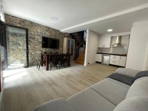 a living room with a couch and a table at La Corrolada de Ana in Debodes