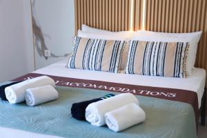 a couple of beds with folded towels on them at Apartment Simply 302 in Gázion