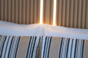 a bed with a pillow and a tie on it at Apartment Simply 302 in Gázion +14 photos