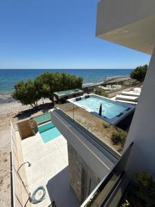 a swimming pool with the ocean in the background at Luxury Villa Asana in Koutsourás