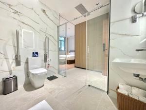a bathroom with a toilet and a sink and a shower at Hotel Hualton in Alcobendas +19 photos