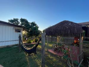 a backyard with a hammock and a hut at Swiss Chalets - Thermas Water Park in Águas de São Pedro +7 photos