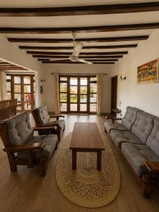 a living room with a couch and a table at Malcom Ocean View Retreat in Pongwe +55 photos