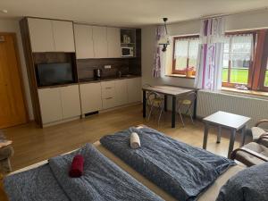 a living room with two beds and a kitchen at U jezera Laka in Prášily