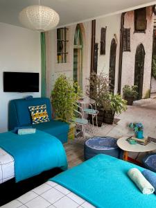 a living room with blue furniture and a patio at Sarajevo, Stari Grad, Apartment in Sarajevo
