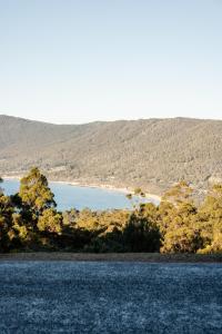 a view of a lake with mountains in the background at Amadiya Port Arthur Villas in Port Arthur