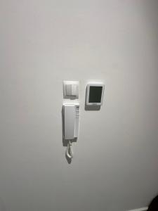 a wall with two soap dispensers on a wall at Apartament Gdański Harward lokal nr 2 in Gdańsk
