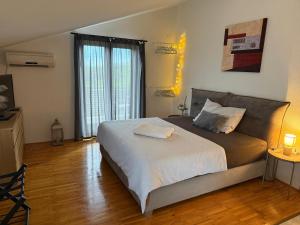 a bedroom with a large bed with white sheets at Ferienhaus Marija mit Pool in Vilanija +33 photos