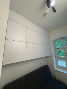 a living room with a couch and a window at Apartament Gdański Harward lokal nr 2 in Gdańsk +1 photo