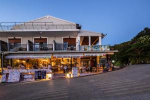 a building with a store on the side of a street at Marea Blue Seaview Apartments of Santa Barbara in Marathias