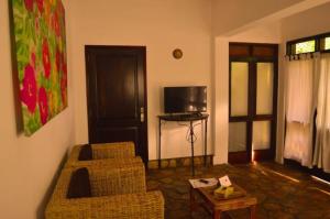 a living room with a couch and a table at Caffè Roma l'originale in Kampala