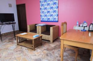 a living room with a couch and a table at Caffè Roma l'originale in Kampala +7 photos