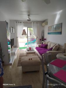 a living room with a couch and a table at location appartement isla plana espagne in Isla Plana