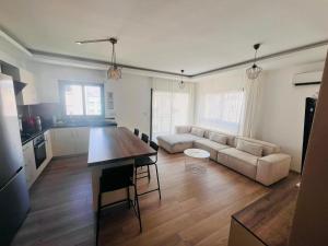 a kitchen and living room with a table and a couch at Aslan House in Nicosia