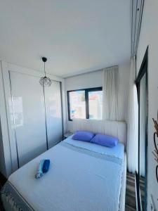 a bedroom with a bed with two blue pillows at Aslan House in Nicosia