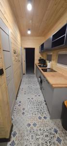 a kitchen with a tile floor and a counter top at Domek SPA z sauną i jacuzzi - Level780 in Koszarawa +7 photos