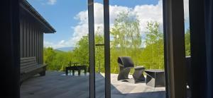 a view from a glass door of a patio at Domek SPA z sauną i jacuzzi - Level780 in Koszarawa