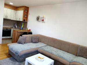 a living room with a couch and a table at Apartman 40 in Modriča +9 photos