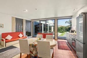 a kitchen and living room with a table and chairs at Casa de Férias Da Padroa in Braga