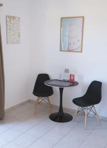 a table and two chairs in a room at Apartment Simply 206 in Gázion