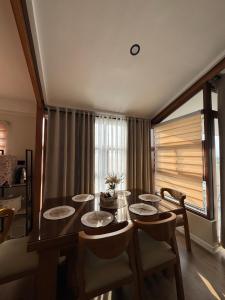 a dining room with a table and chairs and a window at Casa Attika - Modern Glasshouse with Skyline Views in Antipolo