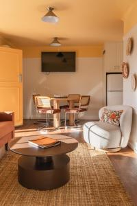 a living room with a table and chairs at Amadiya Port Arthur Villas in Port Arthur