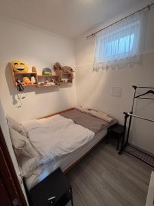 a small bedroom with a bed and a window at TanúHill Garden in Tapolca