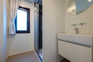 a bathroom with a sink and a mirror and a window at Etrusco Camping Village in Casiano +72 photos