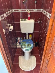 a bathroom with a toilet with a palm tree on the seat at TanúHill Garden in Tapolca +16 photos