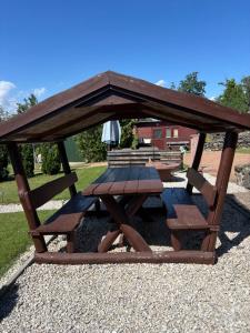 a picnic table and benches in a gazebo at TanúHill Garden in Tapolca