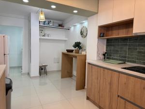 a kitchen with wooden cabinets and a counter top at Cazare Târgu Secuiesc in Târgu Secuiesc