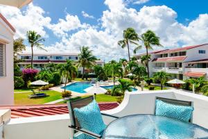a view of the pool from the balcony of a resort at Antigua Village Beach Resort in Saint Johnʼs