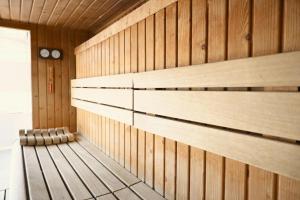 a sauna with wooden walls and a bench in it at Hotel Best Andorra Center in Andorra la Vella +42 photos