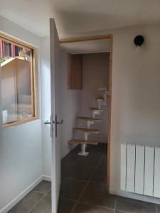 a hallway with a staircase in a house at Appartement proche Taizé Cluny in Massilly +2 photos