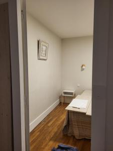 a room with a bed and a table in it at Appartement proche Taizé Cluny in Massilly
