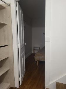 a door leading to a bedroom with a bed at Appartement proche Taizé Cluny in Massilly
