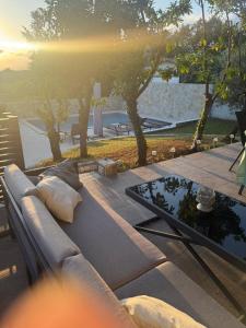 a couch sitting on a patio with a table at Ferienhaus Marija mit Pool in Vilanija
