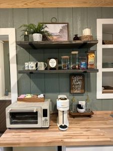 a counter with a microwave on top of a table at 5 Oaks Casita in Abilene