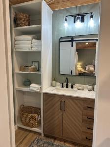a bathroom with a sink and a mirror at 5 Oaks Casita in Abilene +11 photos