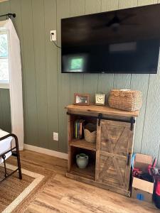 a living room with a tv on a wall at 5 Oaks Casita in Abilene