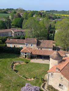an aerial view of a group of buildings with roofs at Charmante Demeure 17ème 4ch-3sdb in Bioussac