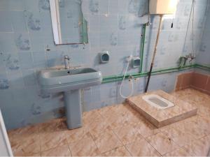 a bathroom with a sink and a mirror at Turkish beach hostel in Muscat +7 photos