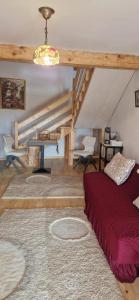 a living room with a bed and a staircase at Casuta Letitiei in Şirnea