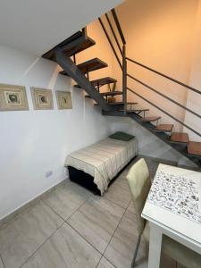 a bedroom with a bed and a stair case at Karina Apartamentos in La Rioja