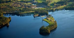 an island in the middle of a large body of water at Stølsdokken Lodge in Sanderstølen +14 photos