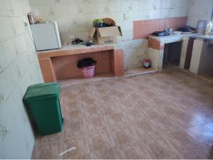 a dirty kitchen with a counter and a sink at Turkish beach hostel in Muscat