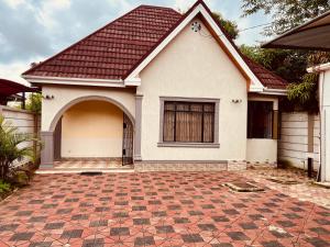 a house with a red roof and a brick driveway at Makali Private Villa- 2En-Suite Bedrooms in Arusha