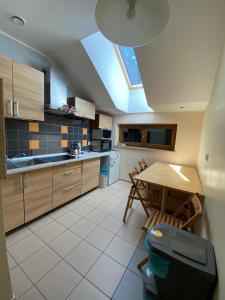 a kitchen with a table and a dining room at Pensjonat Roma in Pszczew