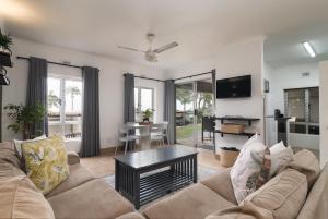 a living room with a couch and a table at Ballito Beachfront Resort - 34 Chaka Chalets in Ballito