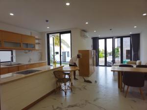 a man is packing a box in a kitchen at Resort Long Hải in Binh Chau